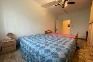 a bedroom with a bed in a room with a ceiling at La Pietra sul Mare - Happy Rentals in Pietra Ligure +9 photos