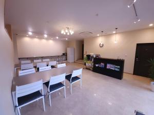 a conference room with a long table and chairs at HOTEL PAiKAJi in Ishigaki Island