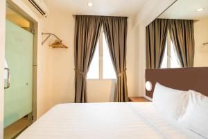 Postel nebo postele na pokoji v ubytování Tune Hotel Georgetown Penang