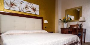 Voodi või voodid majutusasutuse Hotel Flora toas
