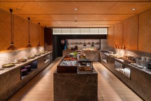a large kitchen with a buffet of food at JOYA Hotel Chengdu High Technology in Chengdu