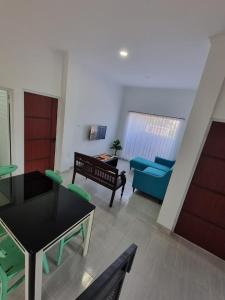 a living room with a couch and a table at Asaan homestay in Ciburial