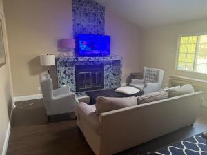 a living room with a couch and a fireplace at Large Private Room Near Meta & Tech Hubs in Menlo Park