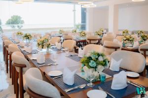 a large conference room with tables and chairs with flowers at Marine Bay Colombo in Colombo