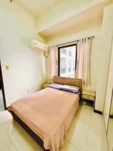 a bedroom with a bed and a window at Vincondotel Malate Manila 2BR Admiral 2823 in Manila +23 photos
