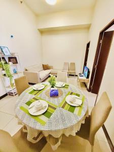 a table in a living room with a table and chairs at Vincondotel Malate Manila 2BR Admiral 2823 in Manila