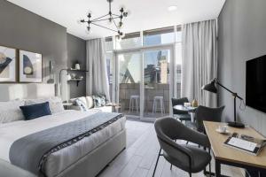 a bedroom with a king sized bed and a desk and chair at Silkhaus Dubai Financial Center studio in Burj Daman in Dubai
