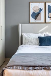 a bedroom with a bed with two pictures on the wall at Silkhaus Dubai Financial Center studio in Burj Daman in Dubai