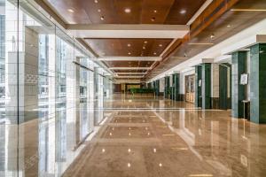 an empty hallway in a building with glass windows at Silkhaus Dubai Financial Center studio in Burj Daman in Dubai