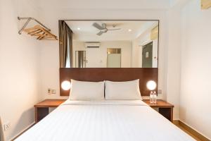 Postel nebo postele na pokoji v ubytování Tune Hotel Georgetown Penang