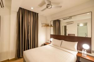 Postel nebo postele na pokoji v ubytování Tune Hotel Georgetown Penang