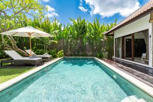 a swimming pool with an umbrella and a house at Villa Nolan - Modern 3BR Private Villa with Pool in Padonan, Canggu in Kerobokan +82 photos
