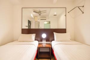 Postel nebo postele na pokoji v ubytování Tune Hotel Georgetown Penang