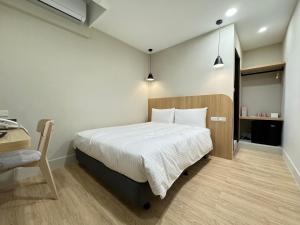 Postel nebo postele na pokoji v ubytování Yoshi Hotel - Tainan Sinmei Branch
