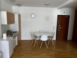 a kitchen with a table and chairs in a room at Ratko Peris in Novalja