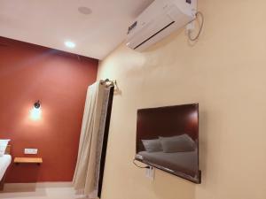 a bedroom with a bed with a mirror and a air conditioner at Nature yatra in Achra +6 photos
