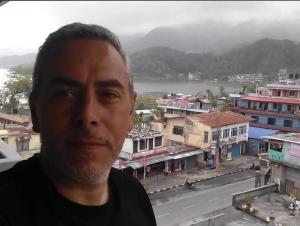 a man standing in front of a view of a city at Hotel Blue lake in Pokhara