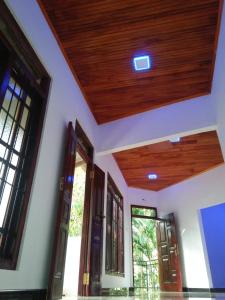 an empty room with a wooden ceiling at Kelani Riverside Retreat in Kitulgala