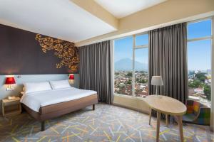 A bed or beds in a room at Ibis Styles Malang