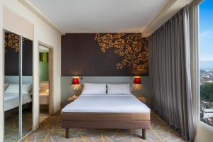 A bed or beds in a room at Ibis Styles Malang