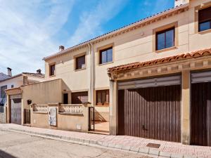 a house with two garages on a street at Casa Rural La Bienservida in Bienservida
