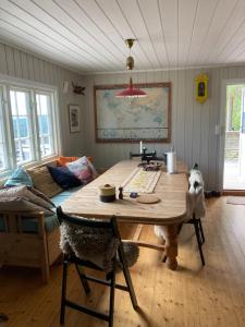 a living room with a wooden table and a couch at Hagaåsen by Norgesbooking - cabin with amazing view in Omholt