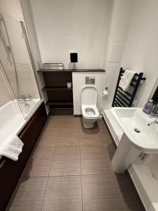 a bathroom with a toilet and a sink at The Marina Quay 1 Bed 1 Bath In Gillingham in Hoo