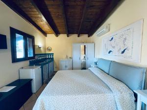 a bedroom with a bed and a wooden ceiling at Vento di Grecale in Favignana