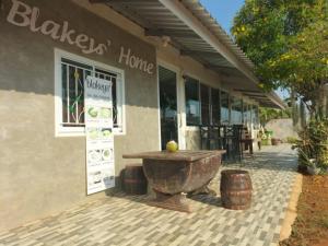 a building with a large bowl in front of a store at Blakeys' Home in Ban Kabok Wan