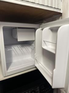 an empty refrigerator with its door open in a kitchen at Magic Apartments 2 in Miercurea-Ciuc