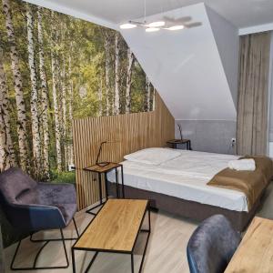 Postel nebo postele na pokoji v ubytování Jarzębinowy Resort & SPA