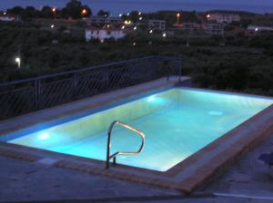 a swimming pool at night with a blue light in it at Sartivista Bed & Breakfast in Sarti