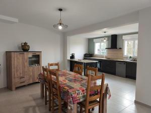 a kitchen and dining room with a table and chairs at Le St Germin'ay in Saint-Germain-sur-Ay