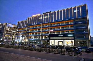 a large building with a lot of windows at Hotel Sky Gold in Ahmedabad