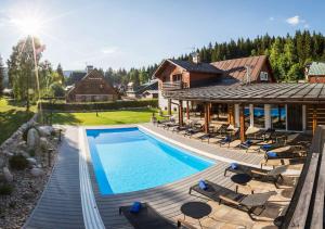 an aerial view of a house with a swimming pool at Chalet Schäfer s vyhřívaným bazénem se slanou vodou in Harrachov