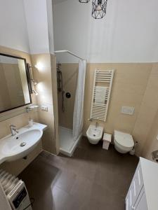 a bathroom with a sink and a toilet and a shower at Charming large palazzo in center Venice for up to 9 people in Venice +43 photos