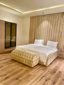 a bedroom with a large bed with a wooden floor at Cozy Ikoyi Retreat in Lagos