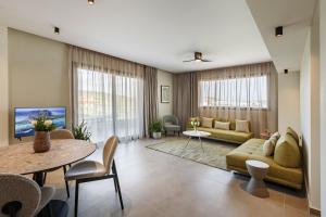 a living room with a couch and a table at Dimi Residence in Nea Moudania