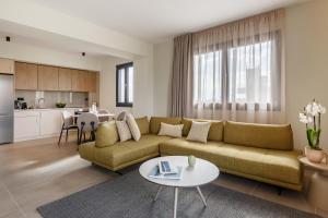 a living room with a couch and a table at Dimi Residence in Nea Moudania