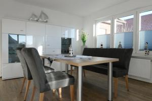 a dining room with a wooden table and chairs at Mole 1 in Norden