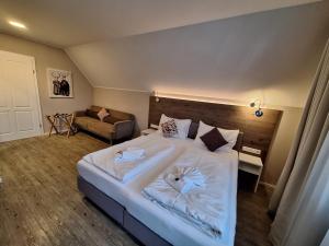 a bedroom with a large bed with two towels on it at Seegasthof Breineder - Familien & Seminarhotel in Mönichwald +81 photos