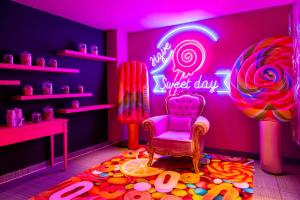 a room with a room with a neon sign and a chair at nhow Brussels Bloom in Brussels