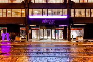 a building with a purple sign on the side of it at nhow Brussels Bloom in Brussels +73 photos