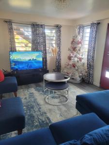 a living room with a christmas tree and a tv at Silverbuttons in Rat Island