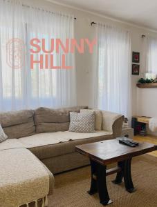 a living room with a couch and a coffee table at Sunny Hill kuća za odmor na Zlataru in Vukovina