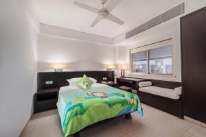 a bedroom with a bed and a desk and a window at Howard Johnson Resort Sanya Bay in Sanya +186 photos