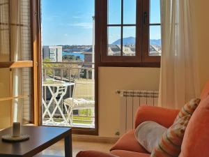 a living room with a couch and a large window at Cinco Soles - 5927 in Isla