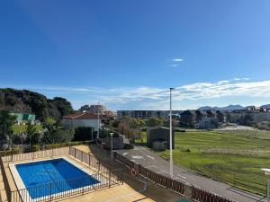 a view of a swimming pool and a field at Cinco Soles - 5927 in Isla