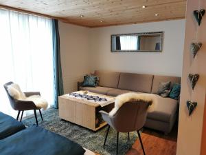 a living room with a couch and a chess board on a table at Strickerhof in Hundwil