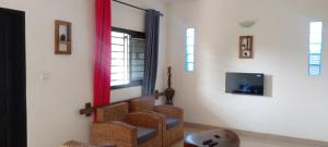 a room with a staircase with a mirror and a tv at Maleh Plus in Kribi